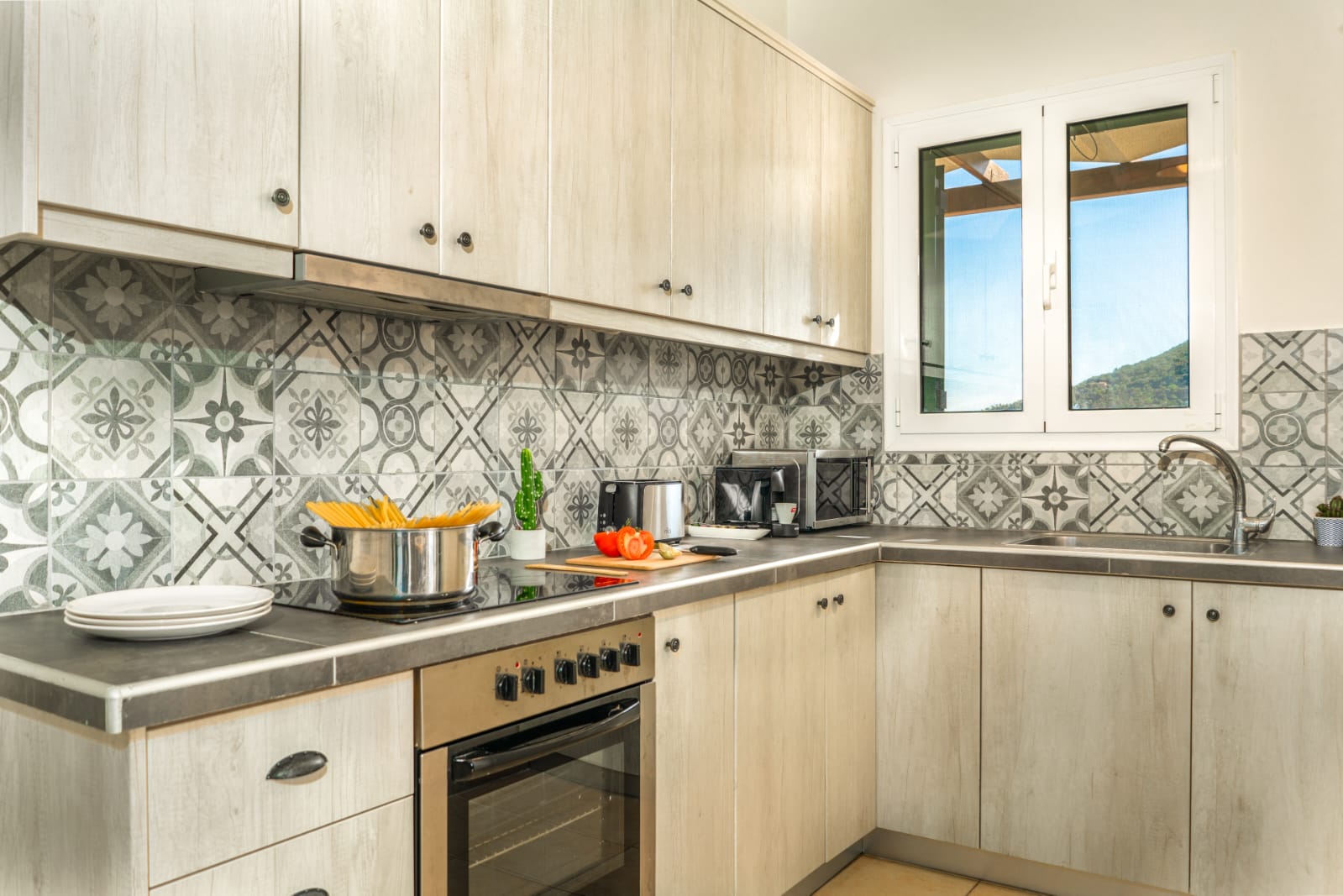 Fully equipped kitchen with patterned tiles