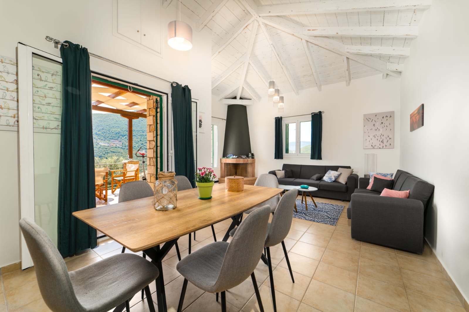 Open-plan dining and living room under a vaulted ceiling