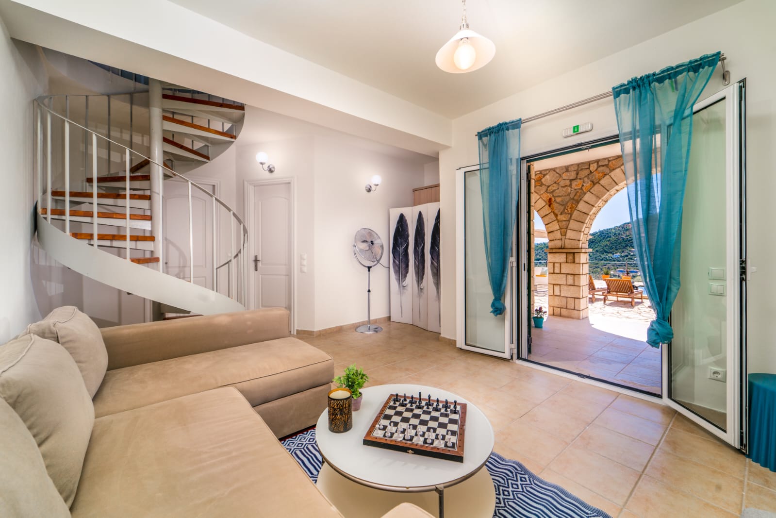 Lounge with spiral staircase opening to the terrace