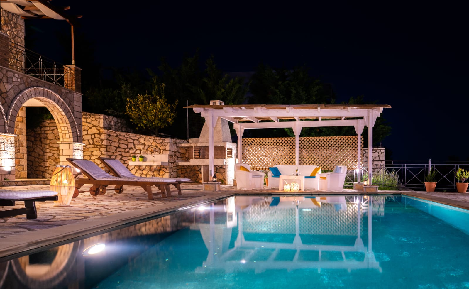 Lantern-lit pergola beside the pool